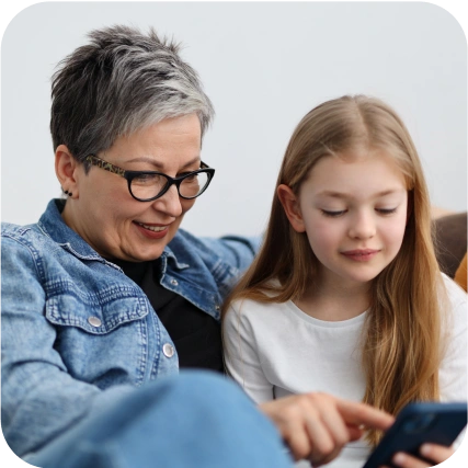 Woman looking at smartphone with child